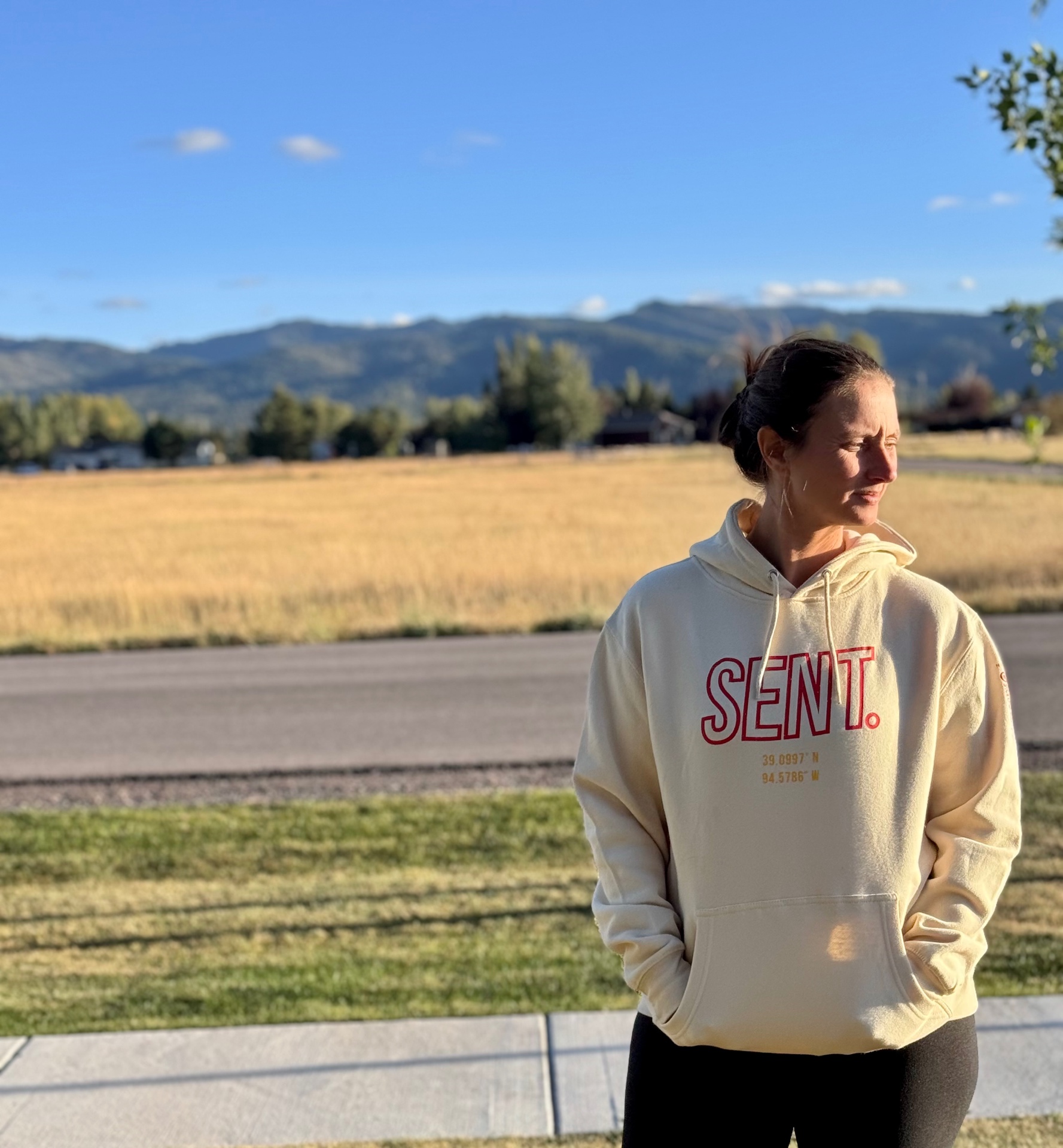 Woman wearing the cream Sow & Cover SENT. hoodie outdoors